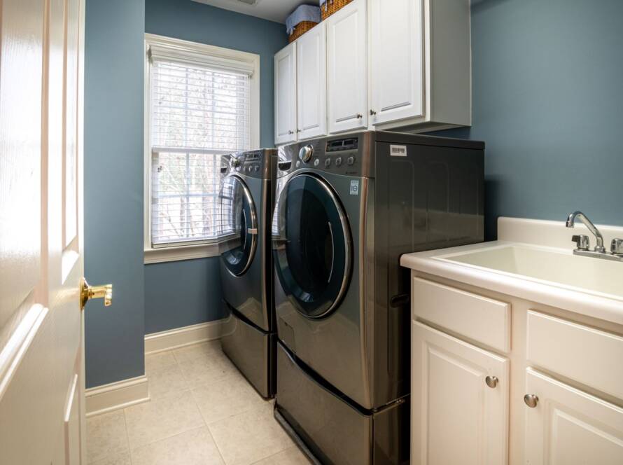 How to wash a gymnastics leotard: front-loading washing machine in a bright laundry room
