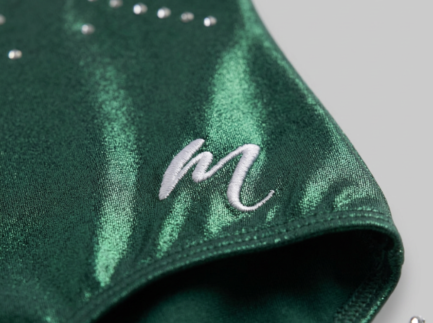 Close-up of a high-quality gymnastics leotard: Modevant metallic fabric, flat seams and rhinestones